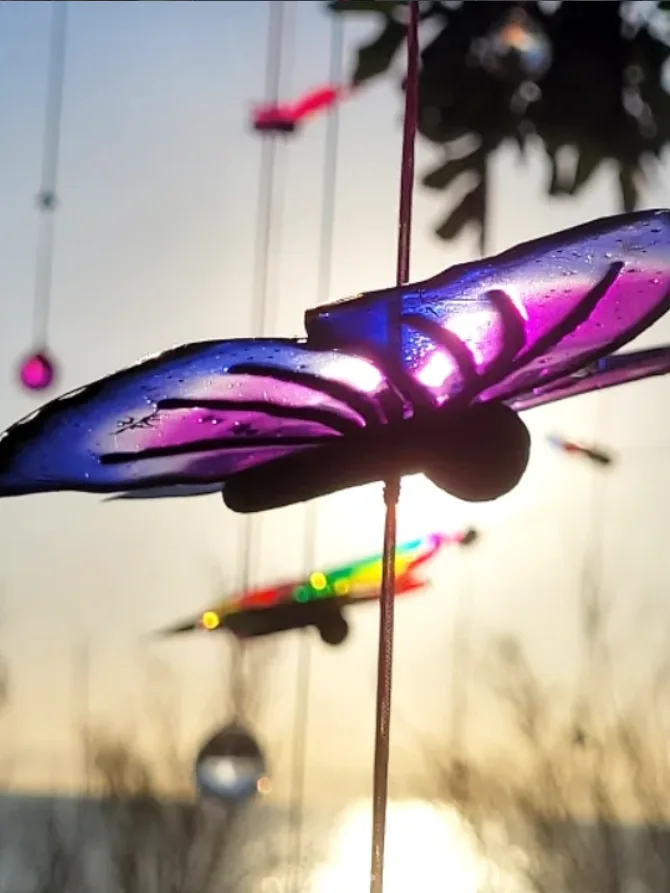 Purple butterfly sculpture at sunset